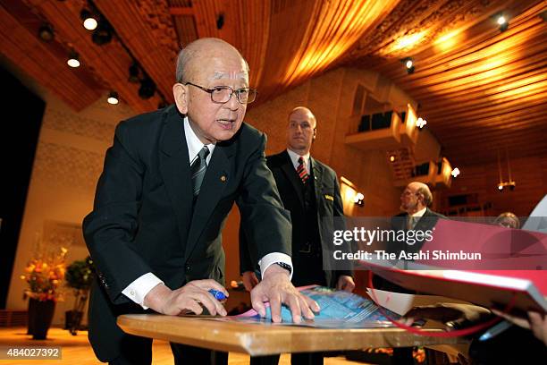 Nobel Prize in Chemistry laureate Akira Suzuki signs autographs after his memorial lecture ahead of the Nobel Prize Award Ceremony on December 8,...