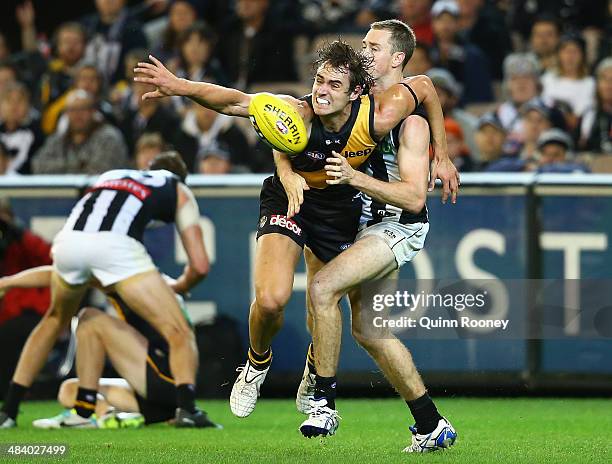 Ben Griffiths of the Tigers attempts to mark infront of Nick Maxwell of the Magpies during the round four AFL match between the Richmond Tigers and...