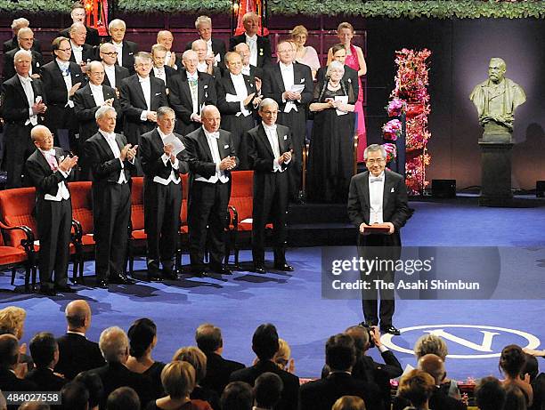 Nobel Prize in Chemistry laureate Eiichi Negishi aknowledges after receiving the medal from the King Carl XVI Gustaf of Sweden during the Nobel Prize...