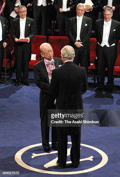 Nobel Prize in Chemistry laureate Akira Suzuki receives the medal from the King Carl XVI Gustaf of Sweden during the Nobel Prize Award Ceremony at...