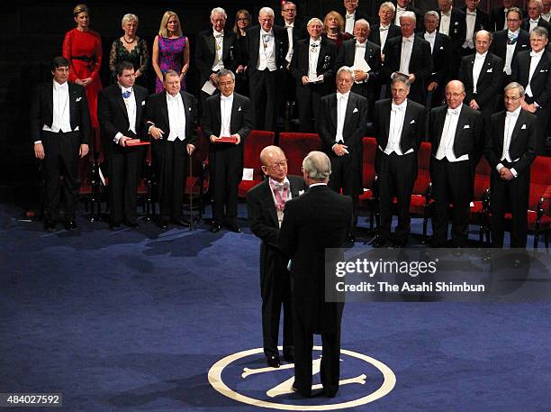Nobel Prize in Chemistry laureate Akira Suzuki receives the medal from the King Carl XVI Gustaf of Sweden during the Nobel Prize Award Ceremony at...