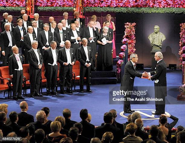Nobel Prize in Chemistry laureate Eiichi Negishi receives the medal from the King Carl XVI Gustaf of Sweden during the Nobel Prize Award Ceremony at...