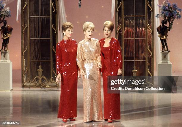 Singers and sisters Phyllis McGuire, Christine McGuire, and Dororthy McGuire of the vocal group "The McGuire Sisters" perform on a TV show in March...