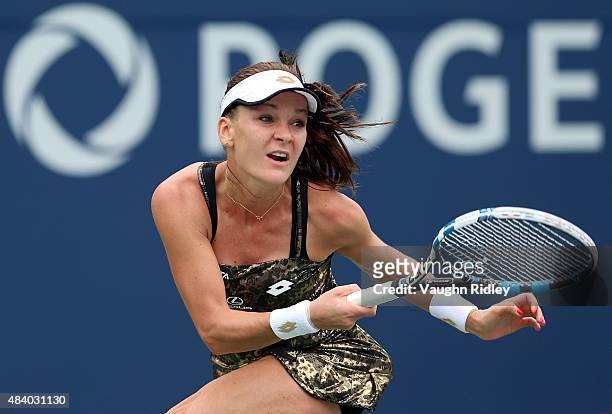 Agnieszka Radwanska of Poland plays a shot against Simona Halep of Romania during Day 5 of the Rogers Cup at the Aviva Centre on August 14, 2015 in...