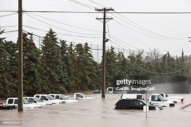 flooded parking lot and damaged vehicles - hailstorm stock pictures, royalty-free photos & images