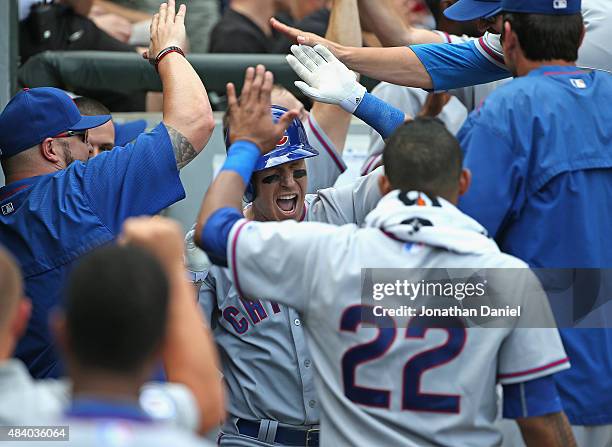 Chris Coghlan of the Chicago Cubs is congratulated by teammates in the dugout after hitting his second home run of the game, a solo shot in the 5th...