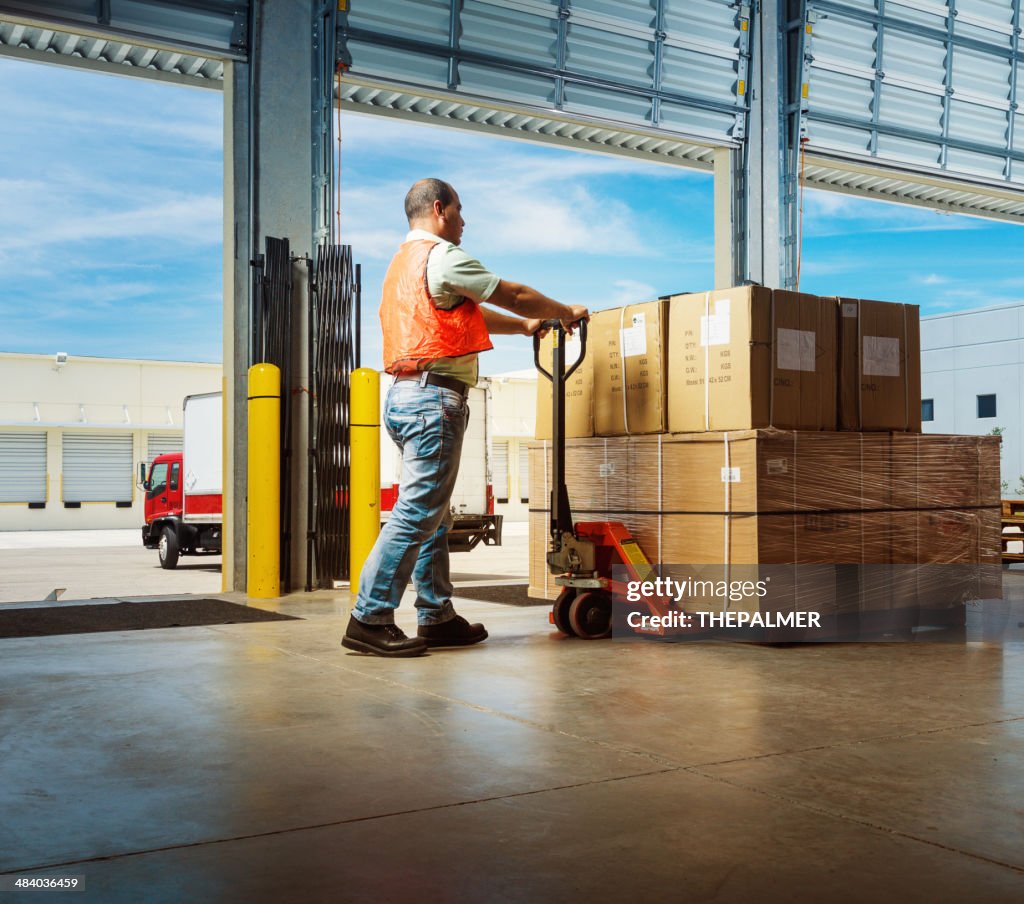 Worker with hand pallet truck