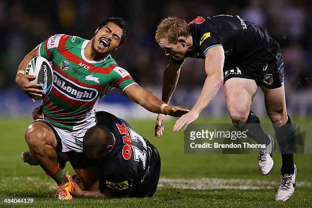 Kirisome Auva'a of the Rabbitohs is tackled by Peter Wallace and Sika Manu of the Panthers during the round 6 NRL match between the Penrith Panthers...