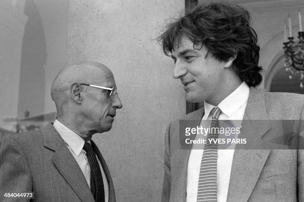 French philosophers Alain Finkielkraut and Michel Foucault leave the Elysee Palace after a meeting with French President Francois Mitterrand on...