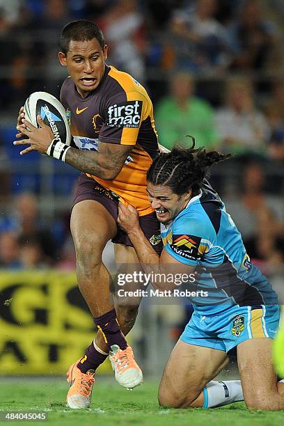 Kevin Gordon of the Titans tackles Ben Barba of the Broncos during the round 6 NRL match between the Gold Coast Titans and the Brisbane Broncos at...