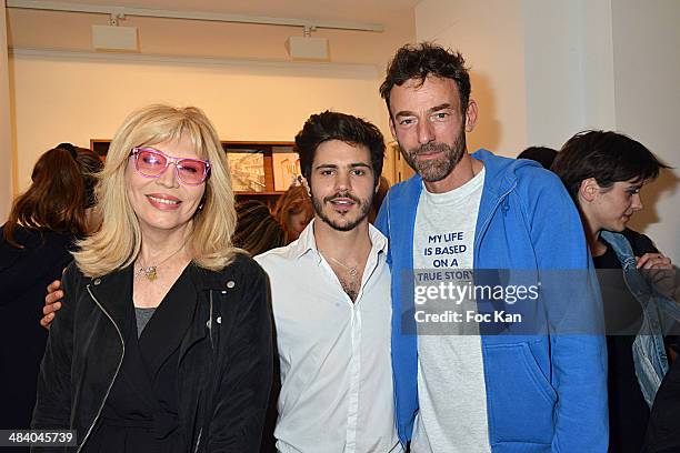 Amanda Lear, Matthieu Charneau and Alain Gossuin attend the 'Heros' Pierre et Gilles Exhibition At Galerie Templon on April 10, 2014 in Paris, France.