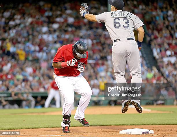 Pablo Sandoval of the Boston Red Sox reaches first as Jesus Montero of the Seattle Mariners fields a late throw in the first inning against the...