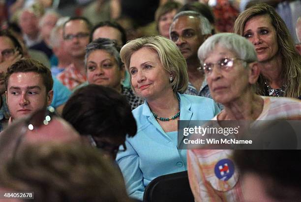 Democratic presidential candidate Hillary Clinton sits in the audience and listens as Democratic presidential candidate Martin O'Malley speaks at the...