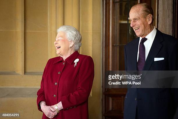 Britain's Queen Elizabeth II and Prince Philip, Duke of Edinburgh react as they bid farewell to Irish President Michael D. Higgins and his wife...