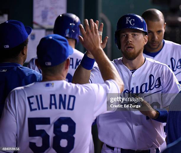 Ben Zobrist of the Kansas City Royals celebrates with Dave Eiland after scoring in the sixth inning against the Los Angeles Angels of Anaheim at...