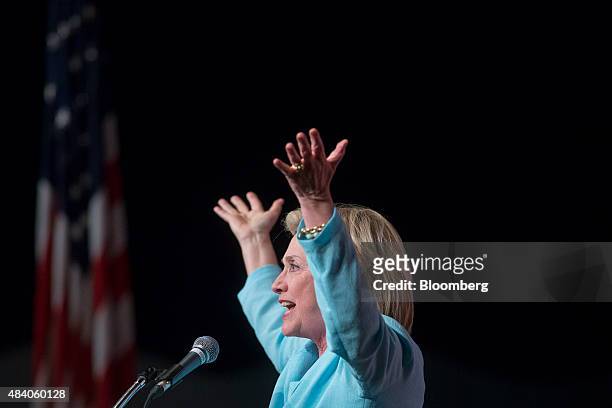 Hillary Clinton, former U.S. Secretary of state and 2016 Democratic presidential candidate, raises her arms as she speaks during the annual...