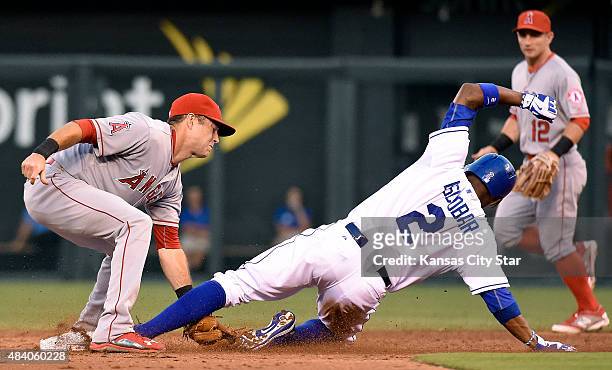 Kansas City Royals' Alcides Escobar steals second under the tag of Los Angeles Angels shortstop Taylor Featherston in the third inning during...