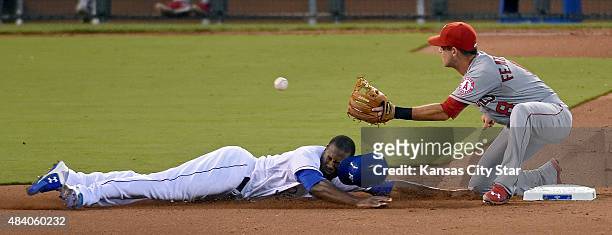Kansas City Royals' Lorenzo Cain steals second before the tag from Los Angeles Angels shortstop Taylor Featherston in the fourth inning during...