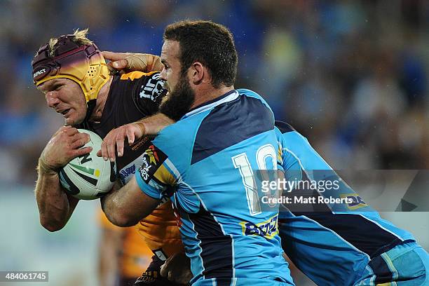 Todd Lowrie of the Broncos is tackled during the round 6 NRL match between the Gold Coast Titans and the Brisbane Broncos at Cbus Super Stadium on...