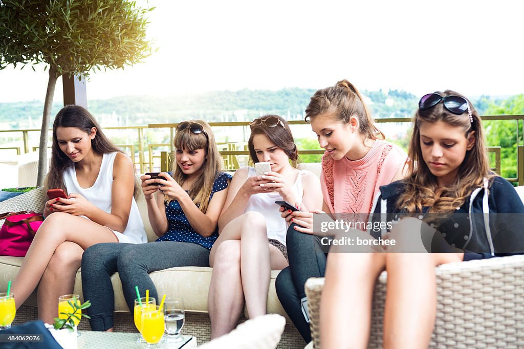 Group Of Young Friends Vasting Time On Their Phones