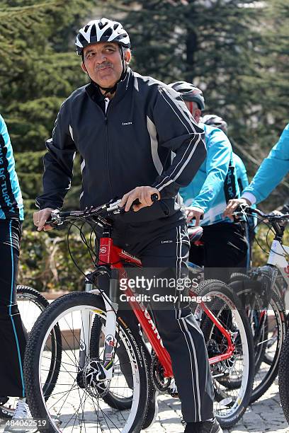 President of Turkey, Abdullah Gul, rides a bicycle with a group of cyclists ahead of the 50th Presidential Cycling Tour at the Cankaya Presidential...