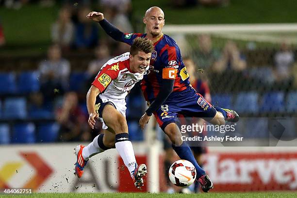 Ruben Zadkovich of the Jets contests the ball against Nathan Konstandopoulos of Adelaide United during the round 27 A-League match between the...