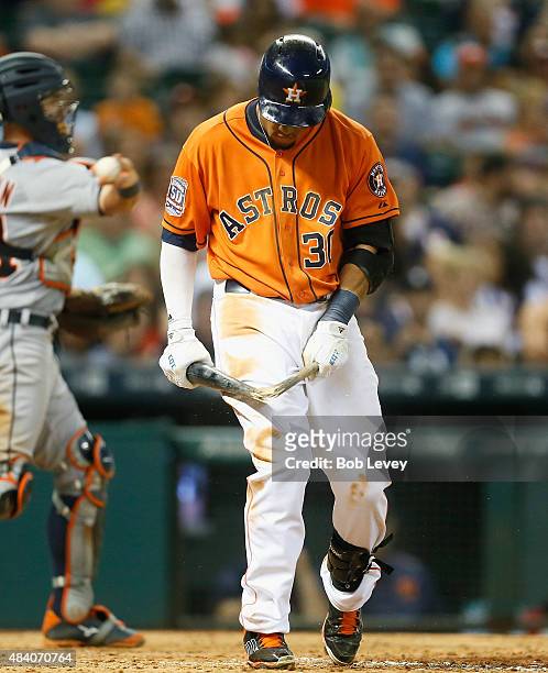 Carlos Gomez of the Houston Astros breaks his bat over his leg after striking out in the eighth inning against the Detroit Tigers at Minute Maid Park...
