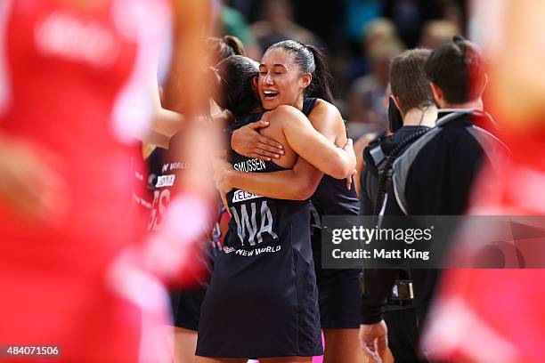 Maria Tutaia of New Zealand celebrates with Grace Rasmussen of New Zealand after their win in the 2015 Netball World Cup Semi Final 1 match between...