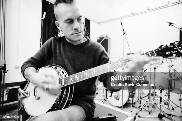 Rob 'The Bass Thing' Jones , of English pop group The Wonder Stuff, playing a banjo at Rockfield Studios, near Monmouth in Wales, December 1989. The...