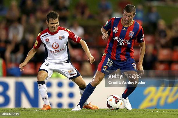 Michael Bridges of the Jets controls the ball ahead of Isaias of Adelaide United during the round 27 A-League match between the Newcastle Jets and...
