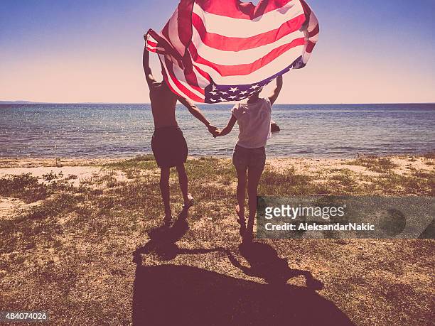 proud americans - american flag beach stock pictures, royalty-free photos & images