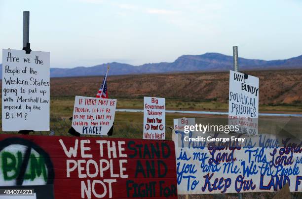 Protesters hang signs on a fence along US. Highway 170 protesting the closure of thousands of acres of Bureau of Land Management land that has been...