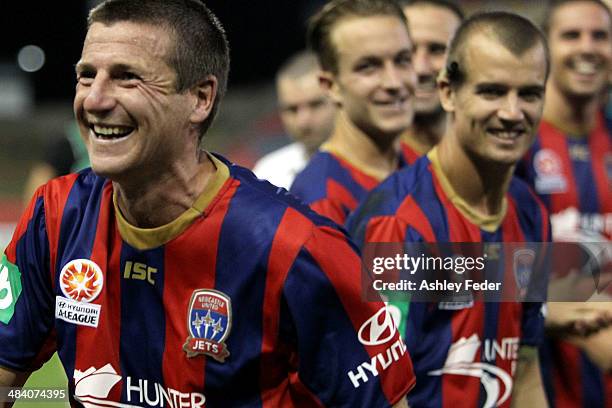 Michael Bridges celebrates the win with teammates cheering him on during his last game during the round 27 A-League match between the Newcastle Jets...