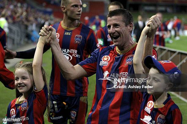 Michael Bridges of the Jets celebrates the win and last game with his children during the round 27 A-League match between the Newcastle Jets and...
