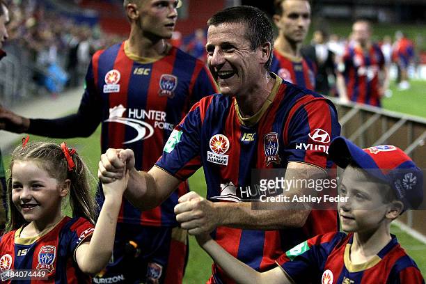 Michael Bridges of the Jets celebrates the win and last game with his children during the round 27 A-League match between the Newcastle Jets and...