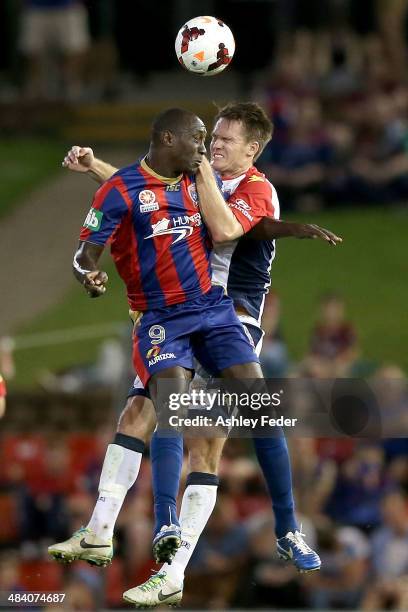 Emile Heskey of the Jets contests the header against Cameron Watson of Adelaide United during the round 27 A-League match between the Newcastle Jets...