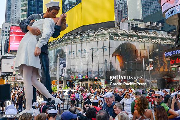 Foot tall replica of John Stweart Johnson II's sculpture based on Eisenstaedt's famous photograph towers over the gathering crowd in Times Square. To...