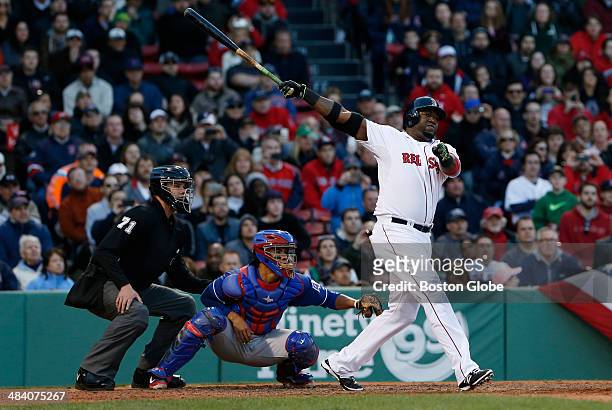 Boston Red Sox designated hitter David Ortiz watches the flight of his three run home run against the Texas Rangers during the eighth inning at...