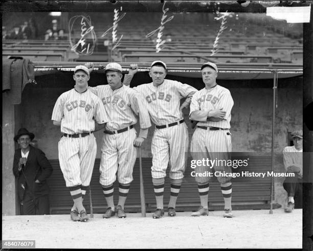 National League's Chicago Cubs baseball players Tyler, Jim Vaughn, Phil Douglas, and Hendrix, standing in front of a dugout at Weeghman Park,...