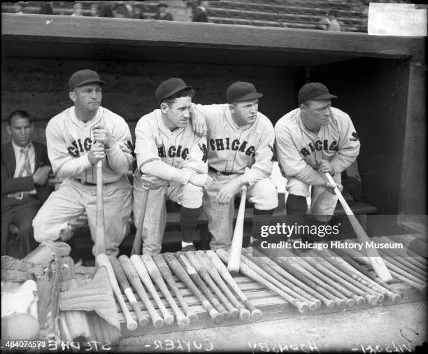 Baseball players Stephenson, Hazen 'Kiki' Cuyler, Rogers Hornsby, and Hack Wilson of the National League's Chicago Cubs, standing in a dugout,...