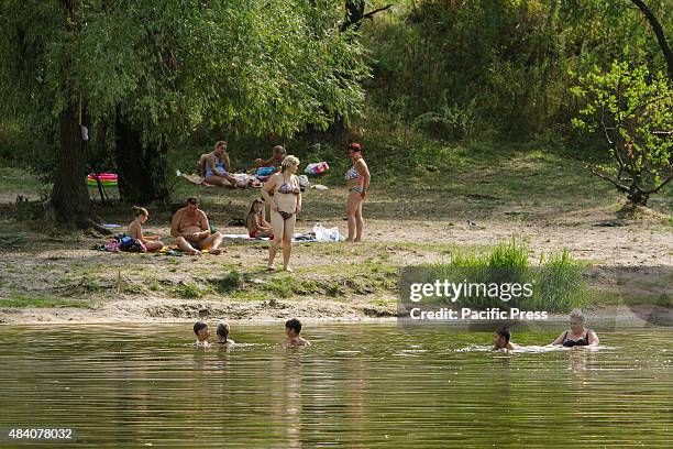 People swim and sunbathe on the shore of Verbne lake in Kiev where several people were infected with leptospirosis. Leptospirosis is an infectious...