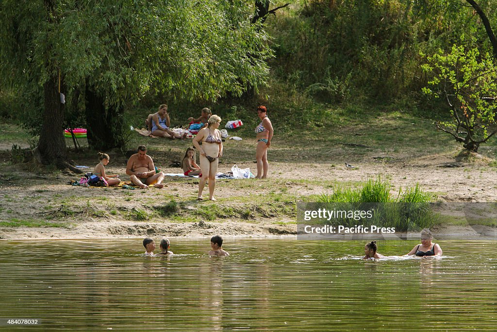 People swim and sunbathe on the shore of Verbne lake in Kiev...