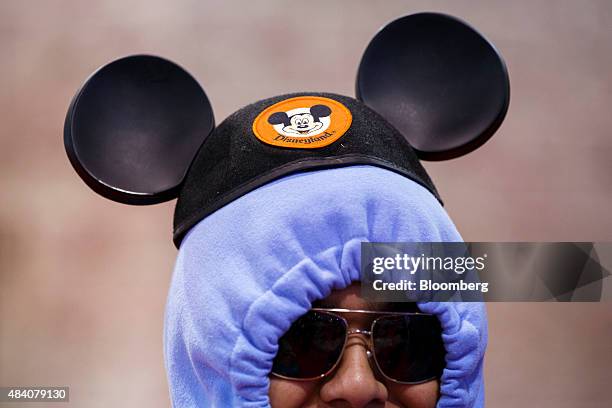 An attendee wears Walt Disney Co.'s Mickey Mouse ears during the D23 Expo 2015 in Anaheim, California, U.S., on Friday, Aug. 14, 2015. The D23 Expo...