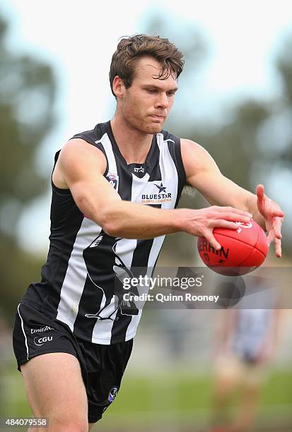 Matt Scharenberg of Collingwood kicks during the round 18 VFL match between Collingwood and North Ballarat Roosters at Victoria Park on August 15,...