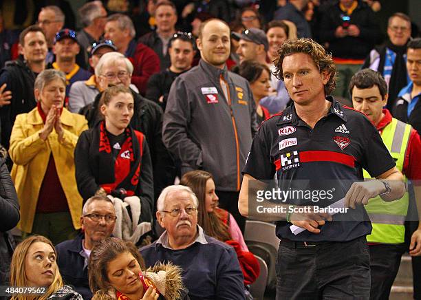 James Hird, coach of the Essendon Bombers walks through Bombers supporters in the crowd at the end of the match during the round 20 AFL match between...