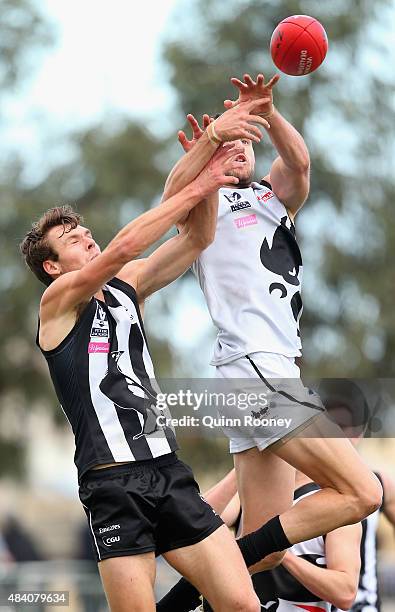 Aaron Black of North Ballarat attempts to mark over the top of Matt Scharenberg of Collingwood during the round 18 VFL match between Collingwood and...