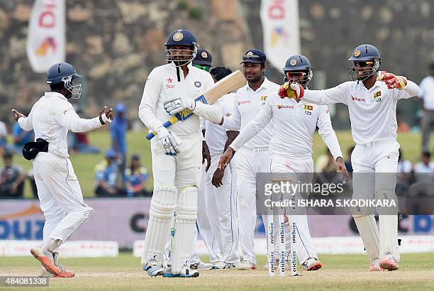 Sri Lankan cricketer Kaushal Silva , Sri Lankan wicketkeeper Dinesh Chandimal and teammates celebrate after dismissing Indian batsman Harbhajan Singh...