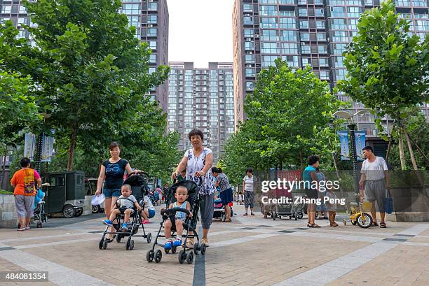 Every afternoon, kids are taken outdoors, playing in the residential community, by their grandmothers or grandfathers, who often left their hometowns...