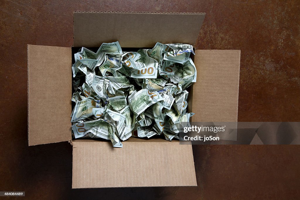 Crumpled 100 USD bills in box