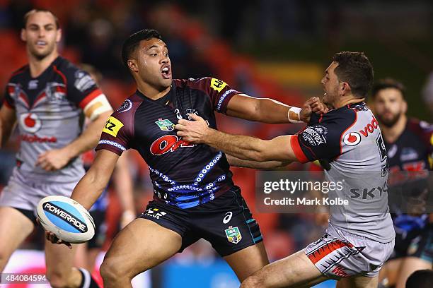 Tupou Sopoaga of the Panthers passes as he is tackled during the round 23 NRL match between the Penrith Panthers and the New Zealand Warriors at...